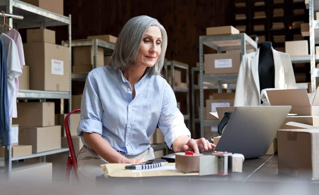lady on laptop in warehouse